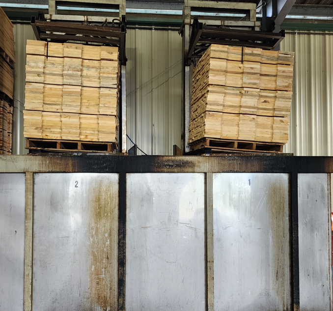 Pallet lumber being treated with Mold Inhibiter
